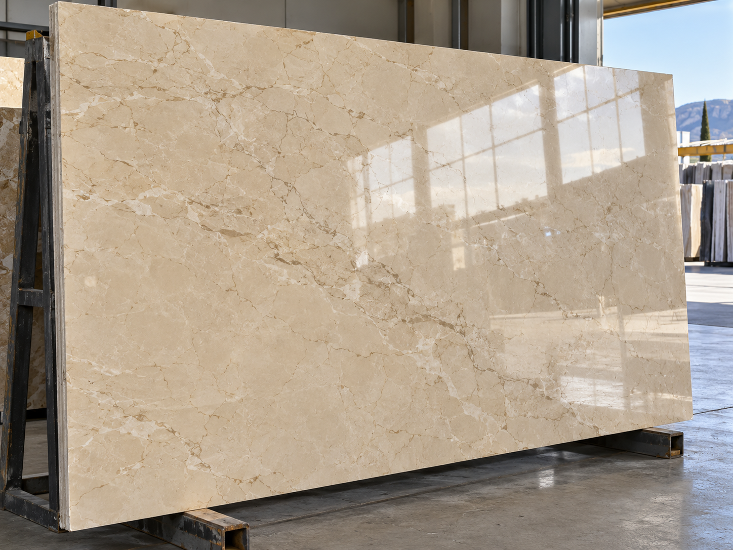 Polished beige marble slab reflecting warehouse daylight