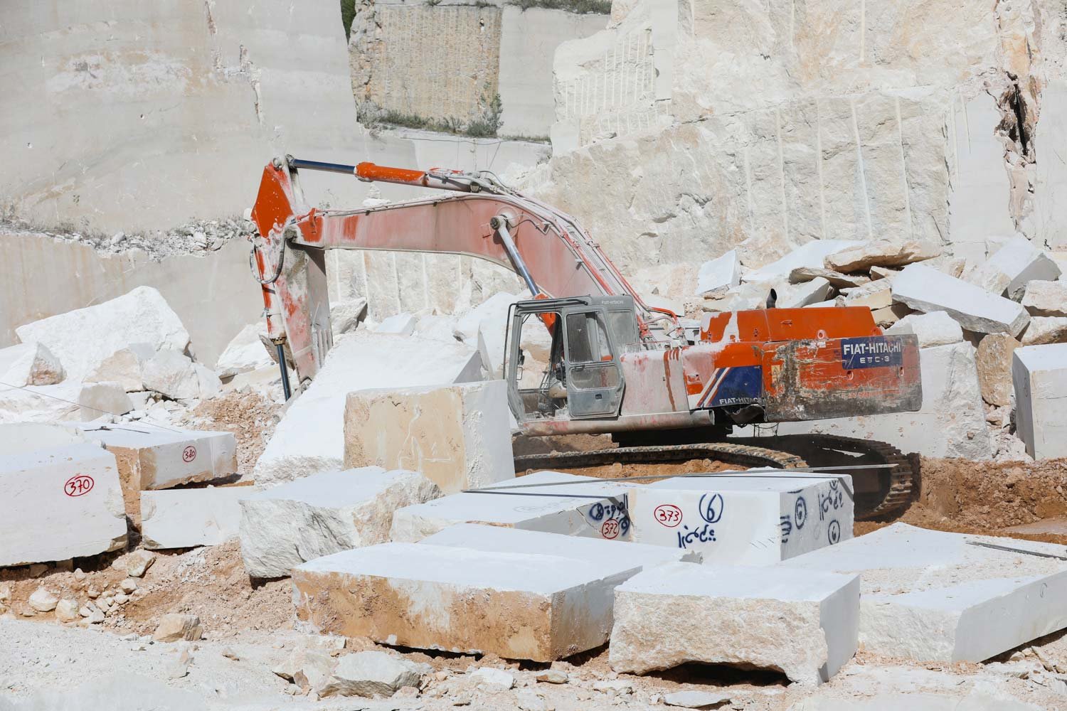 Marble blocks being extracted at a stone quarry with an excavator